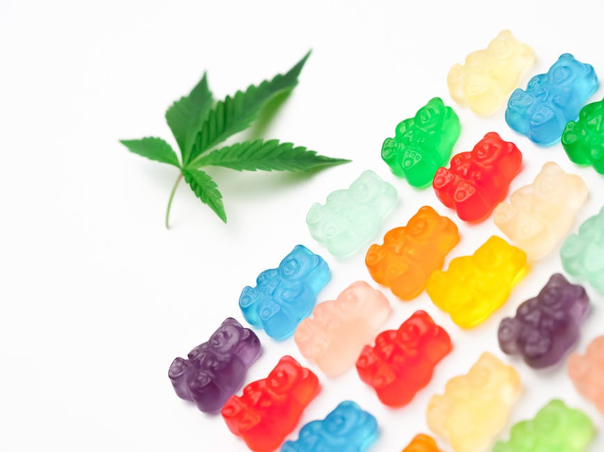 a group of gummy bears and a marijuana leaf